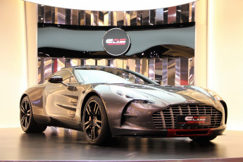 Картинка автомобили aston+martin золотистый