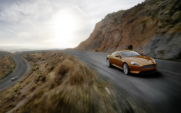 Картинка aston+martin+virage автомобили aston+martin коричневый скорость дорога скалы